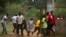 A crowd runs for cover as African Union (AU) peacekeeping soldiers fire warning shots to disperse a crowd near the district of Miskine in Bangui, Feb. 7, 2014. 