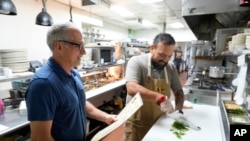 Dan Piacquadio, owner of Harold's Cave Creek Corral, waits to talk with chef and kitchen manager Lucio Osorno, Oct. 3, 2024, in Cave Creek, Ariz.