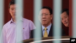 North Korean Ambassador to Malaysia, Kang Chol, center, prepares to get in a car at the embassy in Kuala Lumpur, Malaysia, March 6, 2017. Malaysia is expelling Chol over the poisoning of Kim Jong Nam, the estranged half-brother of North Korea's leader. 