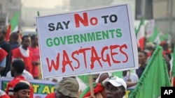 A protester holds a banner during a demonstration against a fuel subsidy removal in Lagos, Nigeria, January 9, 2012.