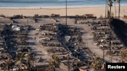 A view shows the remains of homes burned by the Palisades Fire, in the Pacific Palisades neighborhood in Los Angeles, Jan. 12, 2025. 