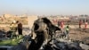 Debris is seen from an Ukrainian plane which crashed as authorities work at the scene in Shahedshahr, southwest of the capital Tehran, Iran, Jan. 8, 2020. 