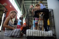 Residents gather at the William Rivera Vocational School converted into a temporary shelter, before the arrival of Tropical Storm Dorian, in Canovanas, Puerto Rico, Aug. 28, 2019. Dorian became a Category 1 hurricane later Wednesday.