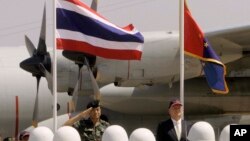 Thailand's Deputy Supreme Commander Gen. Montri Sangkhasap, left, and First Secretary to the U.S. Embassy in Thailand James F. Entwistle, right, review the honor guard at the opening ceremony of the 27th Cobra Gold military exercise in Nakhon...