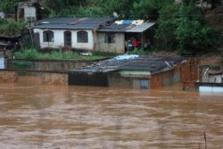 A view of flooded houses caused by heavy rains in Sabara municipality, Minas Gerais state, Brazil, Jan. 24, 2020. The rains led to flooding and landslides that killed dozens, authorities said Jan. 25.