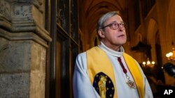 Notre-Dame Cathedral's rector, Patrick Chauvet, speaks during an interview with The Associated-Press at Saint-Germain-l'Auxerrois Church in Paris, Dec. 24, 2021.