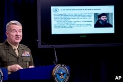 Positive identification information on Abu Bakr al-Baghdadi is displayed as U.S. Central Command Commander Marine Gen. Kenneth McKenzie speaks, Oct. 30, 2019, at a joint press briefing at the Pentagon in Washington.