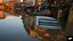 A car is partially submerged in a flooded neighborhood of Srinagar, Indian-controlled Kashmir, Sept. 15, 2014.