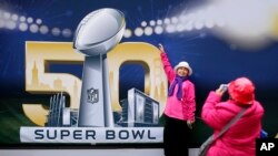 Angie Bagares poses for a photo in front of a Super Bowl 50 sign at Super Bowl City in San Francisco, Feb. 3, 2016.