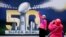Angie Bagares poses for a photo in front of a Super Bowl 50 sign at Super Bowl City in San Francisco, Feb. 3, 2016.