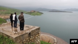 People look at the Dukan dam in Iraq's northern autonomous region of Kurdistan, 65 kms northwest of Suleimaniyah, which was built in 1955 and has reached its highest water levels following heavy rains in the region, April 2, 2019.