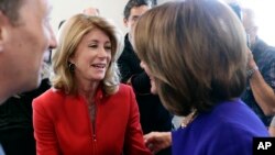 FILE - Former state senator Wendy Davis, center, visits with Speaker of the House Nancy Pelosi, D-Calif., (R), following a stop for a news conference, March 5, 2019, in Austin, Texas.