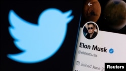 FILE PHOTO: A photo illustration shows Elon Musk's twitter account and the Twitter logo