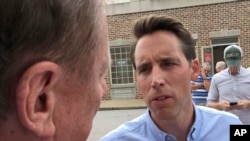 FILE - Republican U.S. Senate candidate Josh Hawley speaks with a man during a campaign rally in suburban St. Louis on Aug. 30, 2018.