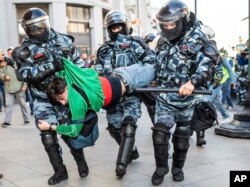 FILE - Police detain a man during a protest in Moscow, Russia, Aug. 10, 2019.
