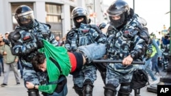 FILE - Police detain a man during a protest in Moscow, Aug. 10, 2019. Thousands rallied against the exclusion of some city council candidates from Moscow's upcoming election, turning out for one of the capital's biggest political protests in years.