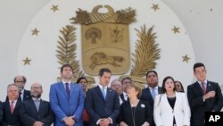 U.N. High Commissioner for Human Rights Michelle Bachelet, third right, poses for a photo with Venezuela's self proclaimed President Juan Guaido, center, and other opposition lawmakers on the steps of the national assembly in Caracas.