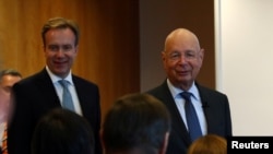 Klaus Schwab, founder and Executive Chairman of the World Economic Forum (WEF), and WEF President Borge Brende arrive for a news conference ahead of the Davos annual meeting in Cologny near Geneva, Switzerland, Jan. 14, 2020.