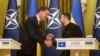 NATO Secretary General Mark Rutte, left, and Ukrainian President Volodymyr Zelenskyy, right, shake hands during press conference in Kyiv, Ukraine, Oct. 3, 2024.