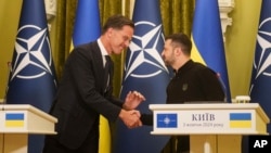 NATO Secretary General Mark Rutte, left, and Ukrainian President Volodymyr Zelenskyy, right, shake hands during press conference in Kyiv, Ukraine, Oct. 3, 2024.