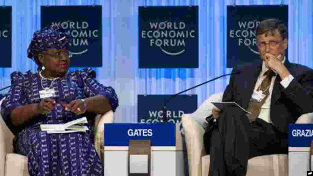 Bill Gates and Nigerian Finance Minister Ngozi Okonjo-Iweala attend a panel session at the World Economic Forum in Davo, Jan. 26, 2012.