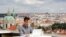 FILE - Joseph Petrila, a 23-year-old job seeker, uses a laptop in a cafe near the Prague Castle following the coronavirus outbreak, in Prague, Czech Republic, July 8, 2020. 