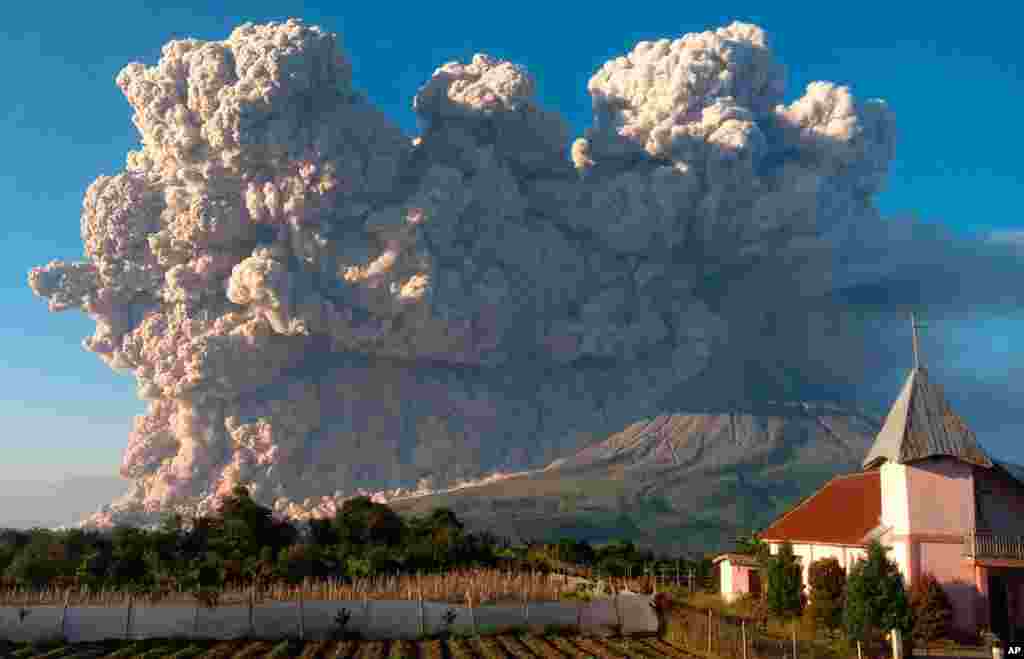 Mount Sinabung spews volcanic material during an eruption in Karo, North Sumatra, Indonesia.
