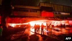 Firemen try to put out a fire inside a mall following a 6.4-magnitude quake in General Santos City, in southern island of Mindanao, on October 16, 2019.