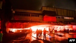 Firemen try to put out a fire inside a mall following a 6.4-magnitude quake in General Santos City, in southern island of Mindanao, on October 16, 2019.