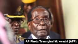 Zimbabwean President Robert Mugabe is seen upon arrival for his annual State of the Nation address at Parliament in Harare, Tuesday, Dec. 6, 2016. 