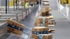 FILE - Amazon packages move along a conveyor at an Amazon warehouse facility on Dec. 17, 2019, in Goodyear, Arizona. 