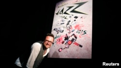 Montreux Jazz Festival Director Mathieu Jaton poses in front of the MJF poster after a press conference to announce performers booked at the 49th annual edition of the famed Swiss festival in July in Lausanne, April 16, 2015.