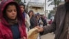 Palestinian women and children queue for bread in Deir al-Balah, Gaza Strip, Nov. 28, 2024.