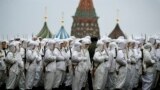 Russian soldiers wear snow gear over Red Army World War II uniforms as they prepare to parade in Red Square in front of St. Basil Cathedral in Moscow, Russia. Thousands of soldiers and military cadets marched across Red Square to mark the 72nd anniversary of a historic World War II parade. The show honored the participants of the Nov. 7, 1941 parade who headed directly to the front lines to defend Moscow from the Nazi forces.
