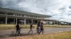 FILE - People walk in front of the Bole International Airport, in Addis Ababa, on March 17, 2020.