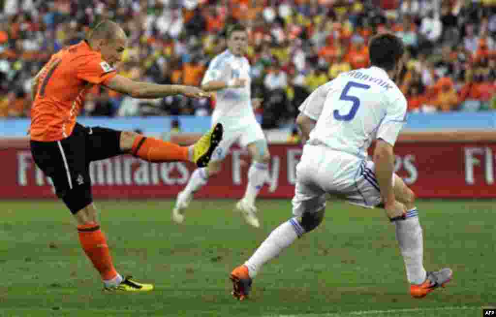 Netherlands' Arjen Robben, left, fires a shot past Slovakia's Radoslav Zabavnik, right, and scores his side's opening goal during the World Cup round of 16 soccer match between the Netherlands and Slovakia at the stadium in Durban, South Africa, Monday, 