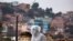 A state department health worker stands in full protective gear while recovering the body of a street vendor who was found at dawn by his neighbors in the Cerro San Miguel neighborhood of Cochabamba, Bolivia, July 25, 2020.