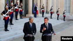 FILE - French President Emmanuel Macron meets Italian Prime Minister Paolo Gentiloni at the Elysee Palace in Paris, France, May 21, 2017. 