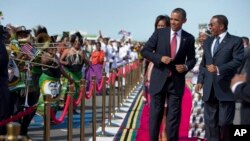 FILE - President Barack Obama, followed by first lady Michelle Obama, in Tanzania, July 1, 2013 during his week-long trip to Africa.