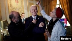 German sculptor Claus Velte and a gallery assistant retouch a waxwork of U.S. President Joe Biden at the Grevin museum, as it prepares to reopen to the public following the easing of coronavirus restrictions in Paris, France.