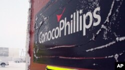 This Feb. 9, 2016, photo shows an ice covered ConocoPhillips sign at the Colville-Delta 5, or as it's more commonly known, CD5, drilling site on Alaska's North Slope. 