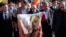 FILE - A man holds a cloth with a depiction of the late Spanish dictator Francisco Franco, during the reinterment of his remains, outside Mingorrubio's cemetery, on the outskirts of Madrid, Spain, Oct. 24, 2019. 