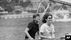 Democratic presidential nominee Sen. John F. Kennedy and wife Jacqueline in cockpit of their sailboat, Victura at Hyannis Port, Mass., Aug. 7, 1960. 
