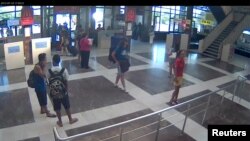 A still picture taken from CCTV surveillance camera shows the suspected bomber (C) at Bulgaria's Burgas airport, July 18, 2012. 