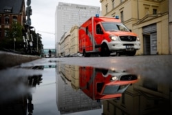 A rescue vehicle drives in front of the central building of the Charite hospital where the Russian opposition leader Alexei Navalny is being treated, in Berlin, Germany, Sept. 2, 2020.