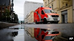 FILE - An emergency vehicle drives in front of the central building of the Charite hospital where the Russian opposition leader Alexei Navalny is being treated, in Berlin, Germany, Sept. 2, 2020.