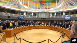 European Union foreign ministers stand for a minute of silence during a meeting of EU foreign ministers at the European Council building in Brussels, Feb. 24, 2025.