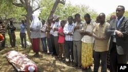 Friends and relatives of Abdisatar Dahir Sabriye, a well known journalist with state-run television who died in Thursday's suicide bomb attack, attend his funeral in Mogadishu, Sept. 21, 2012. 