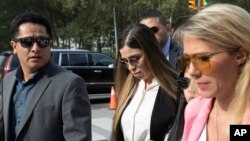 Emma Coronel Aispuro, center, wife of Mexican drug lord Joaquin "El Chapo" Guzman, arrives for his sentencing at Brooklyn federal court, Wednesday, July 17, 2019 in New York.