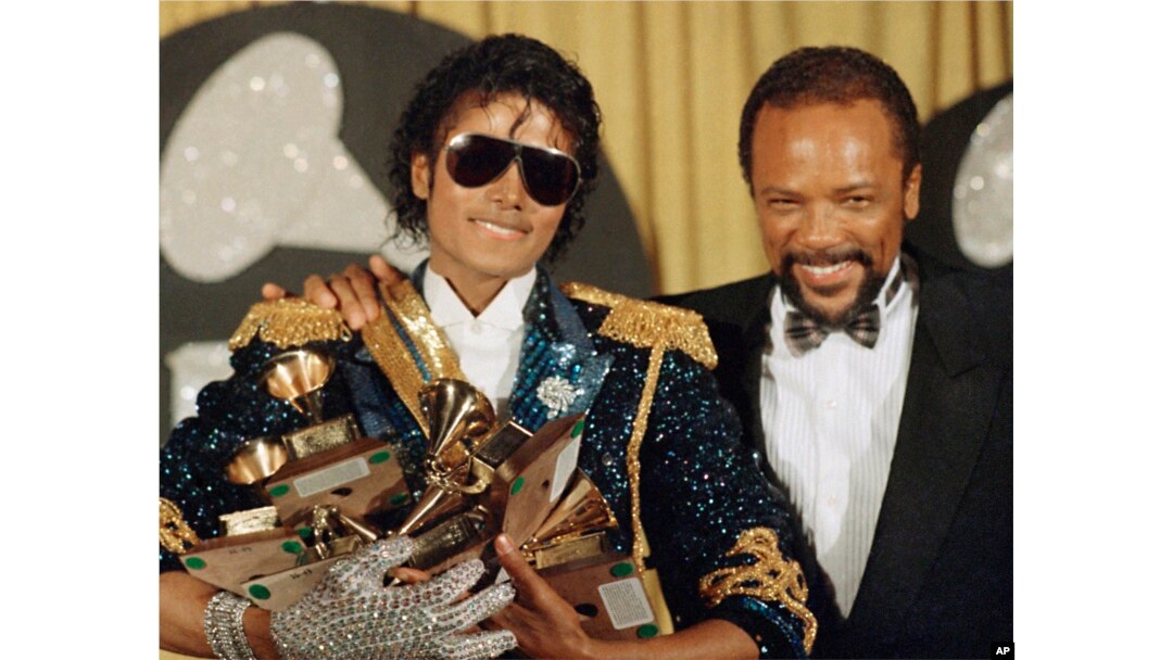 FILE - Michael Jackson, left, holds eight awards as he poses with Quincy Jones at the Grammy Awards in Los Angeles, Feb. 28, 1984. Quincy Jones died at age 91. (AP Photo/Doug Pizac, File)